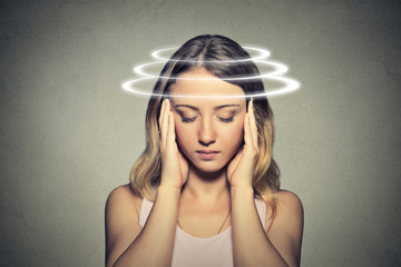 Woman with vertigo. Young female patient suffering from dizziness.